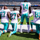 Jarvis Landry of the Miami Dolphins stands as teammates Laremy Tunsil, Maurice Smith and Julius Thomas kneel during the national anthem before a game against the New York Jets at MetLife Stadium in East Rutherford, N.J., on Sept. 24, 2017. (Steven Ryan/Getty Images)